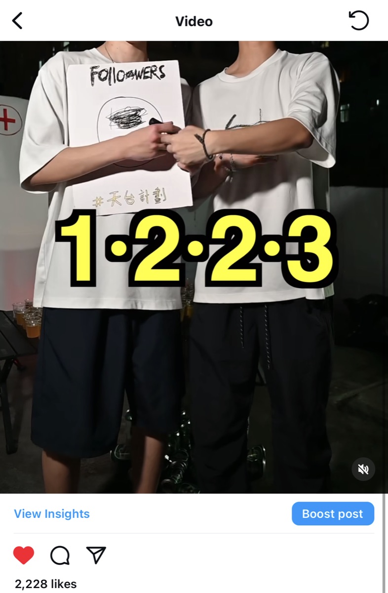 A Reel from the channel: two people in white T-shirts holding a hand-drawn Followers sign, with a big yellow 1·2·2·3 counter. 2,228 likes.